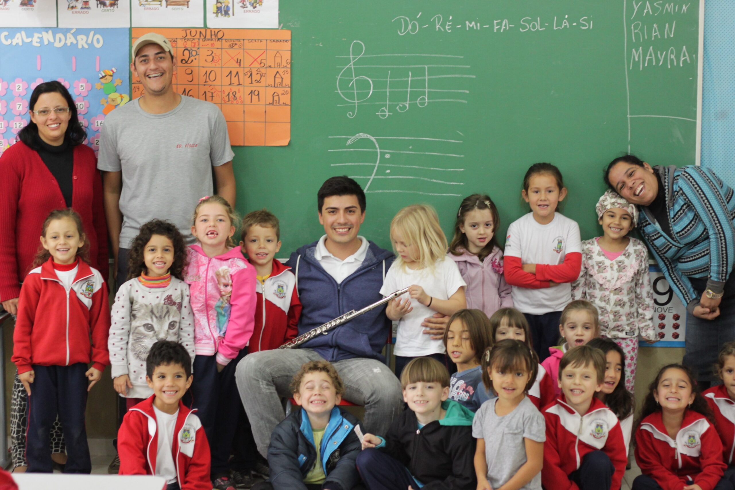 O flautista tocou sua flauta atraindo a atenção das crianças que estudam a letra 'F'.